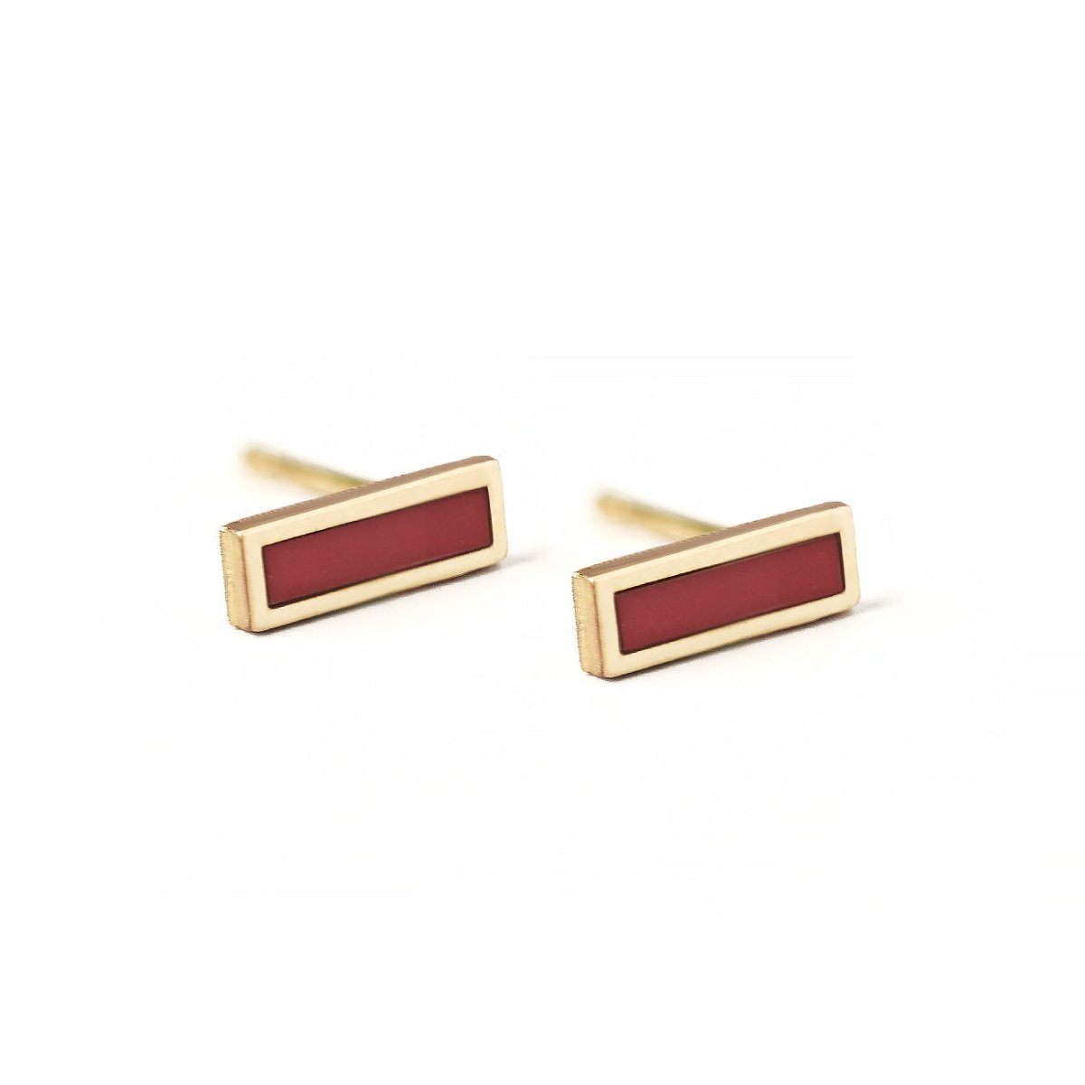 Pair of 14K gold carnelian bar studs with red rectangular stones, on a white background