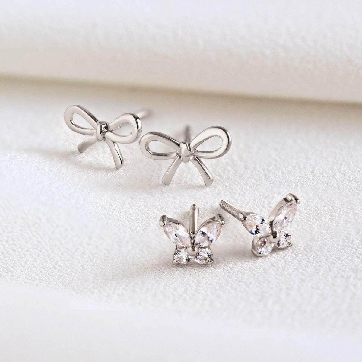 14K white gold crystal butterfly studs, front and side view on a white background