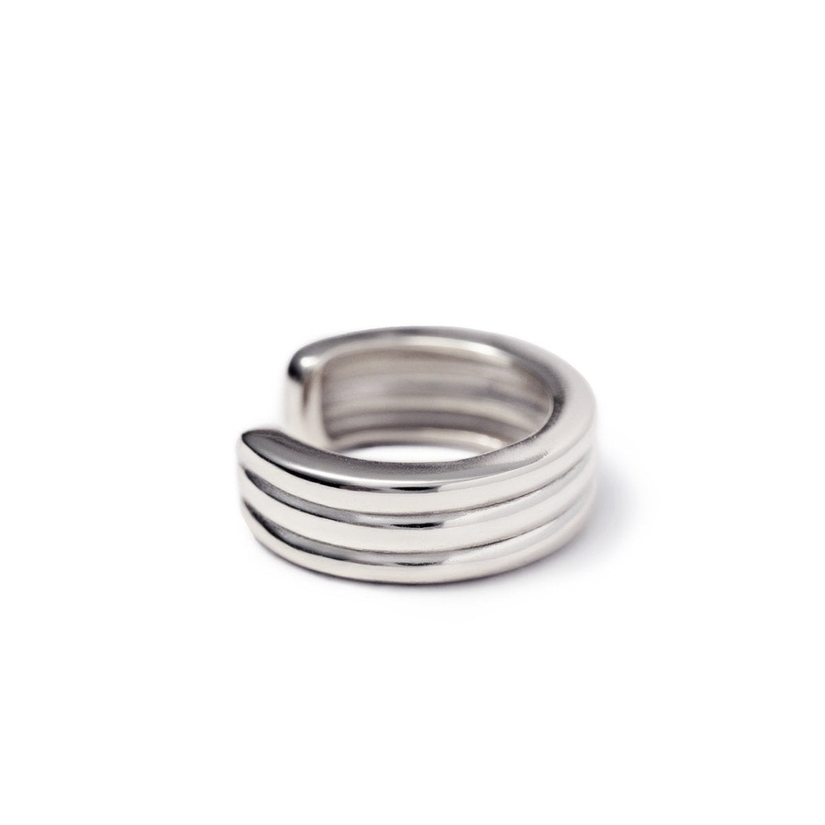 Sterling silver ridged three-band ear cuff, on a white background