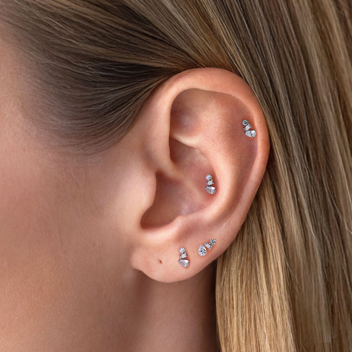 14K gold micro cluster pavé flat back stud earrings, shown on a model