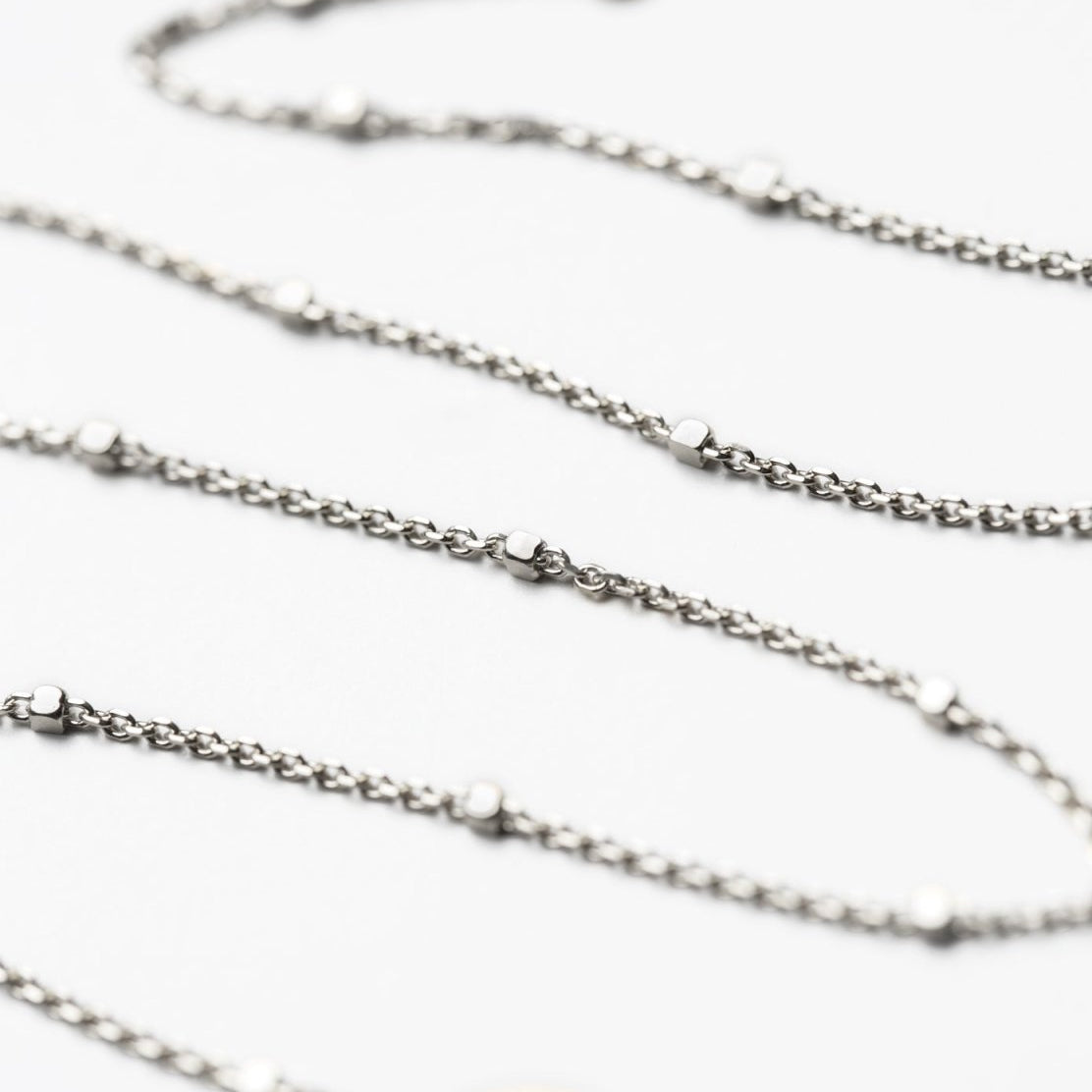 Sterling silver dainty satellite bead chain chokers, close-up detail on a white background