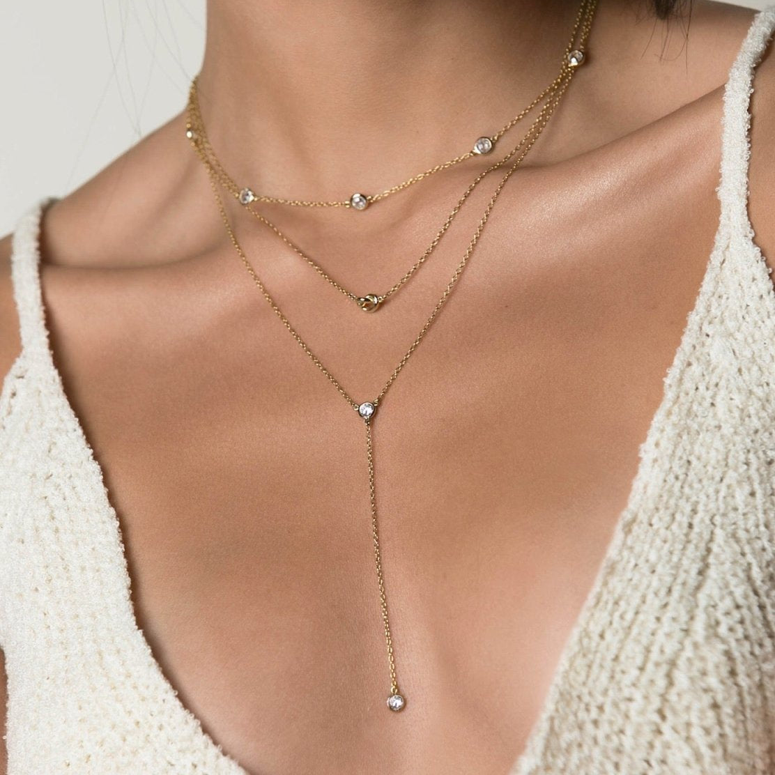 Gold vermeil layered station choker with clear stones and a Y-drop, shown on a model's neckline