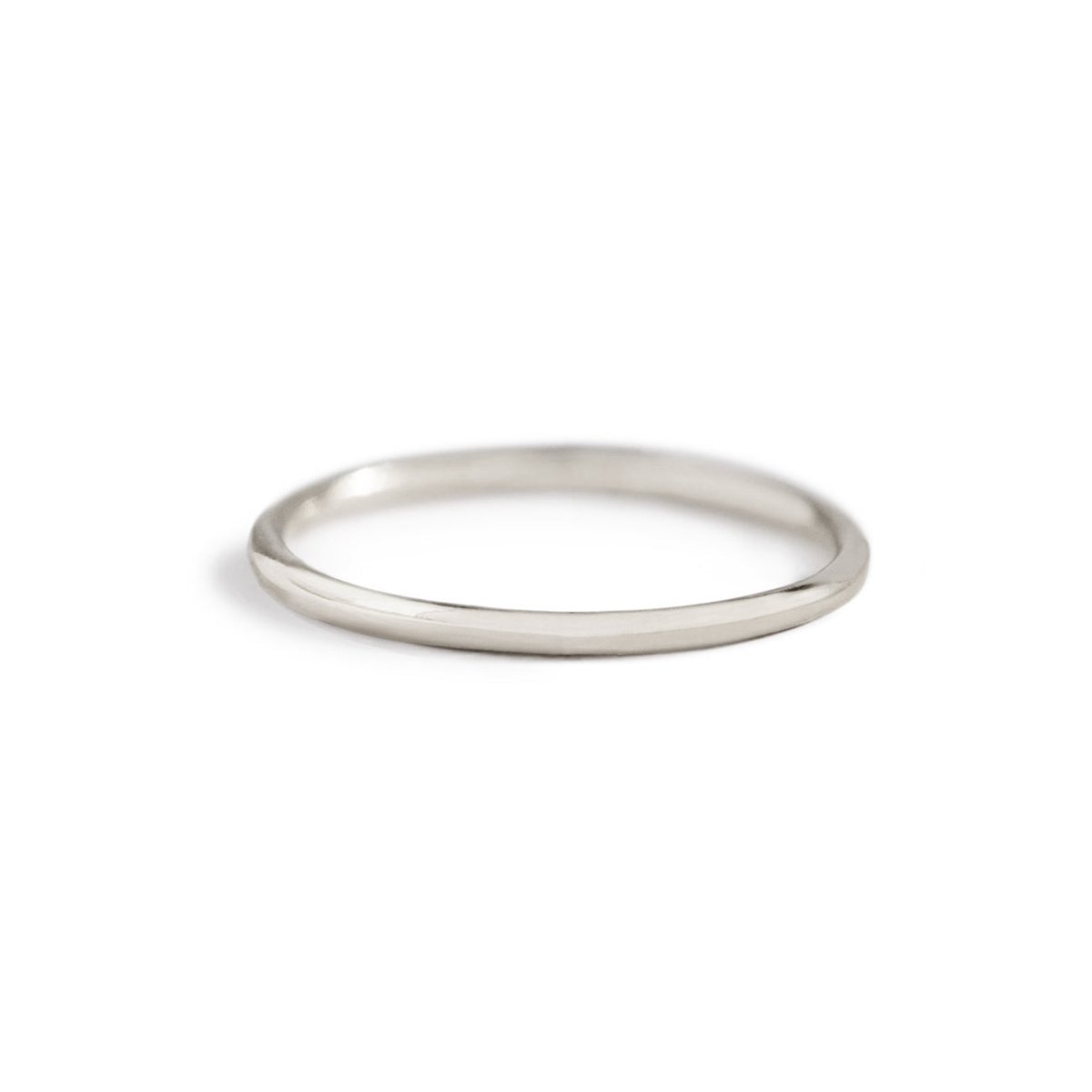 Sterling silver thin stacking ring, a simple smooth round band, on a white background