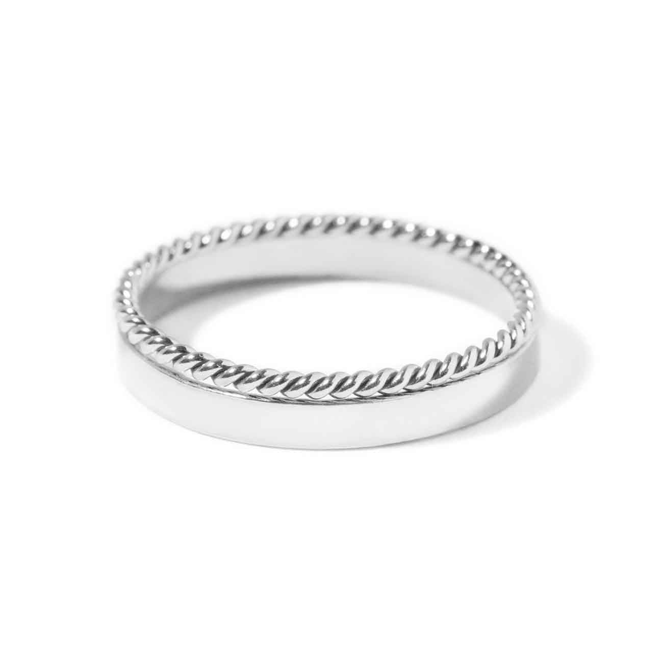 Sterling silver stacking ring set, a flat band paired with a twisted rope band, on a white background