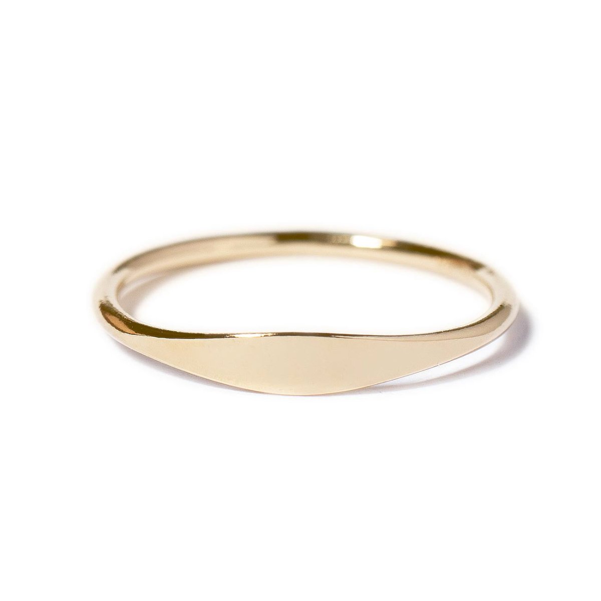 Gold-filled thin signet ring with a smooth flat oval top, on a white background