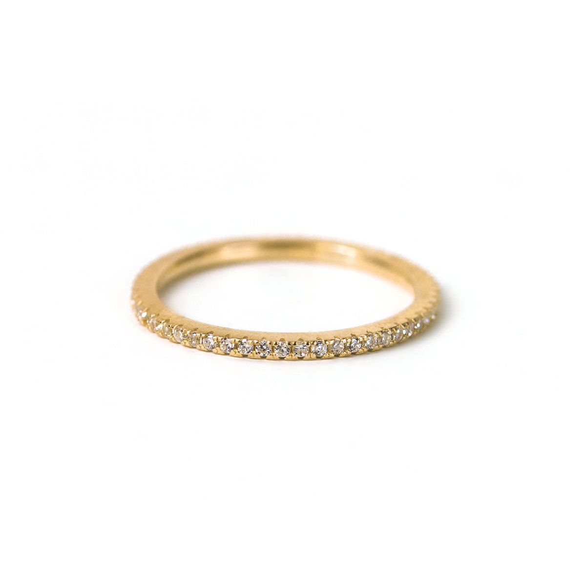 Gold vermeil pavé eternity ring set with white zirconia, on a white background