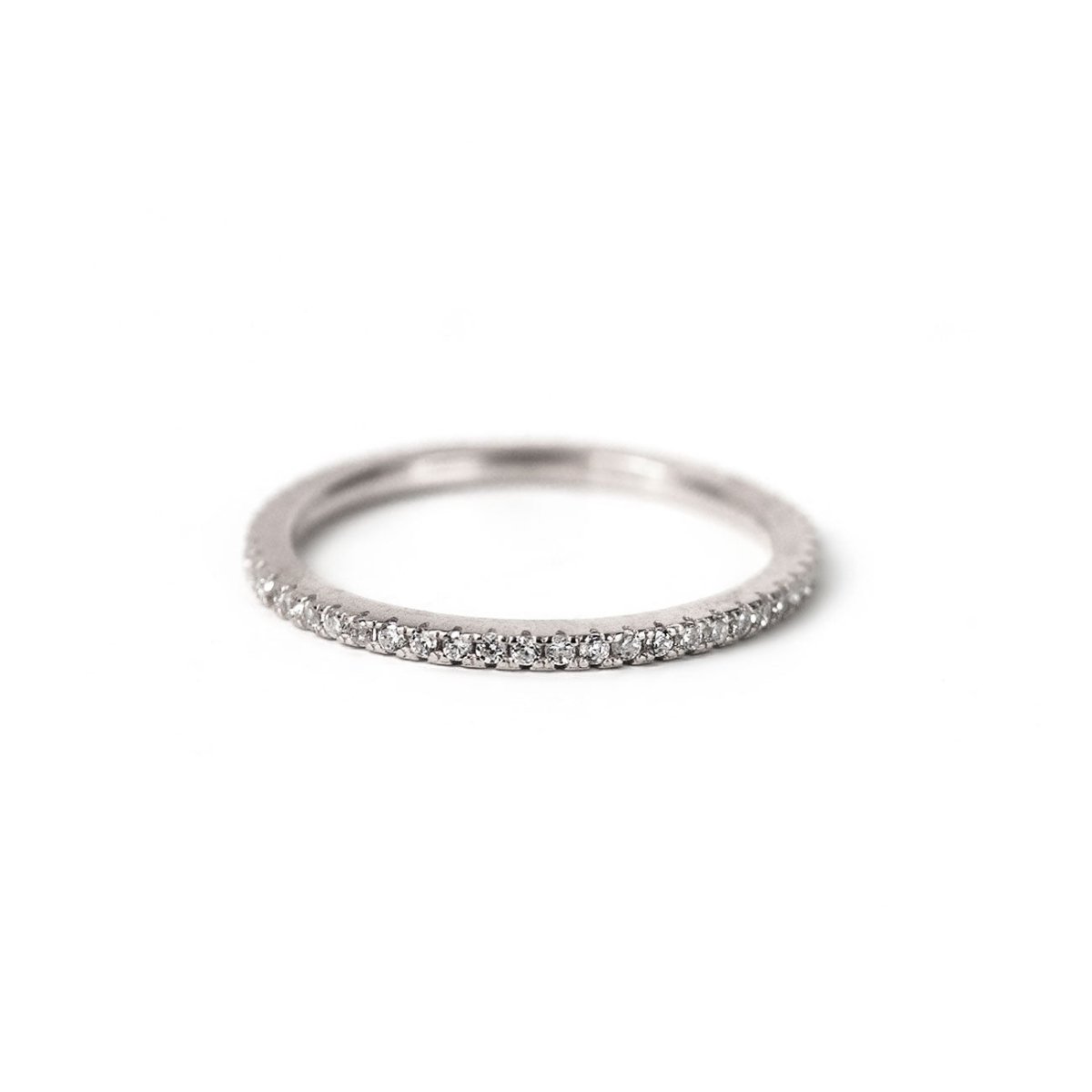 Sterling silver pavé eternity ring set with white zirconia, on a white background