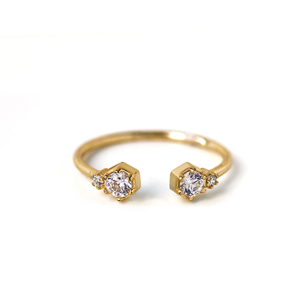 Gold vermeil open cuff ring with two clear zirconia stones in hexagon settings, on a white background
