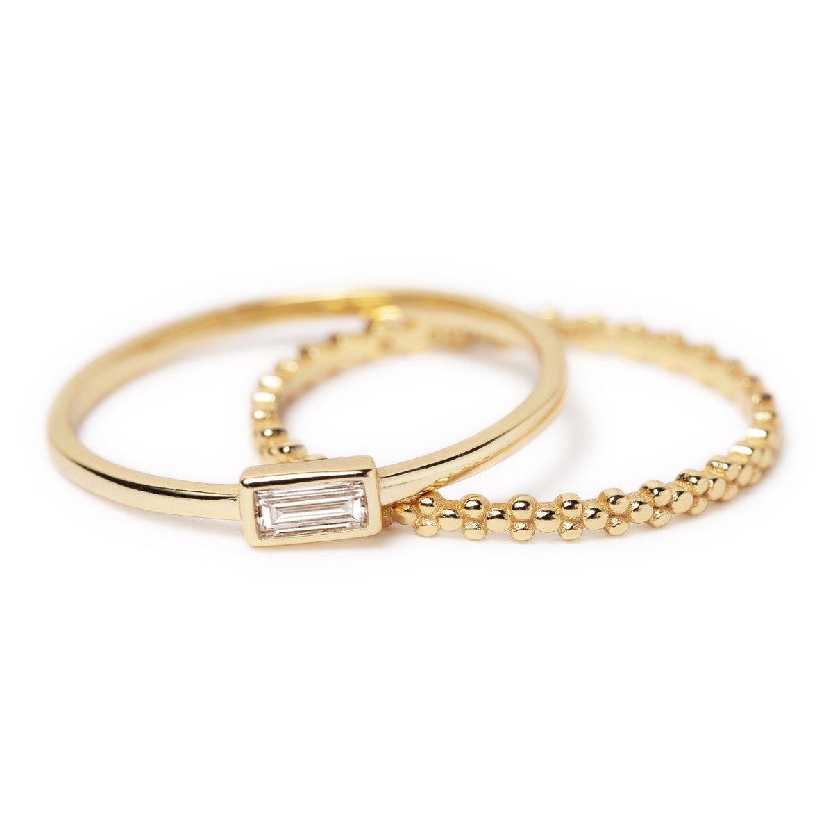 Gold vermeil baguette white zirconia ring and beaded eternity band shown side by side