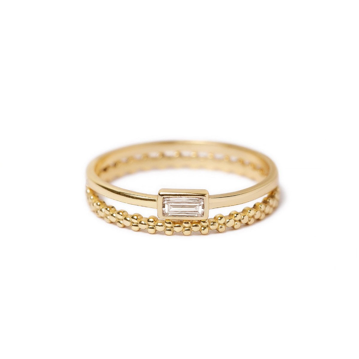 Gold vermeil ring set with a baguette white zirconia and a beaded eternity band, on a white background