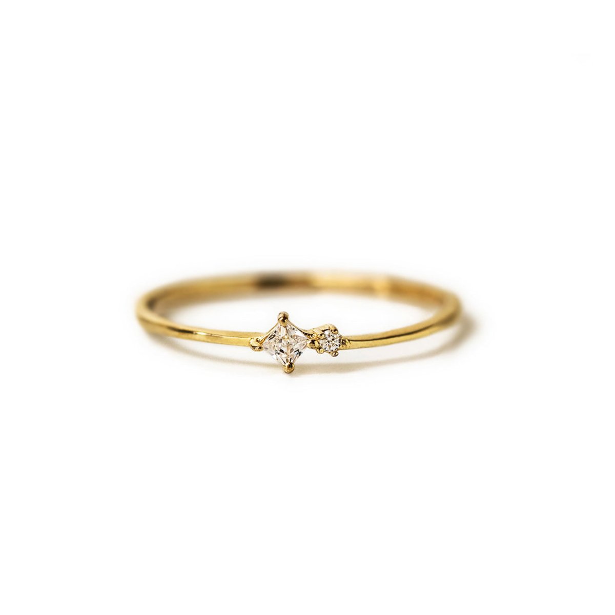 Gold vermeil tiny duo ring with a clear zirconia and a small round stone, on a white background
