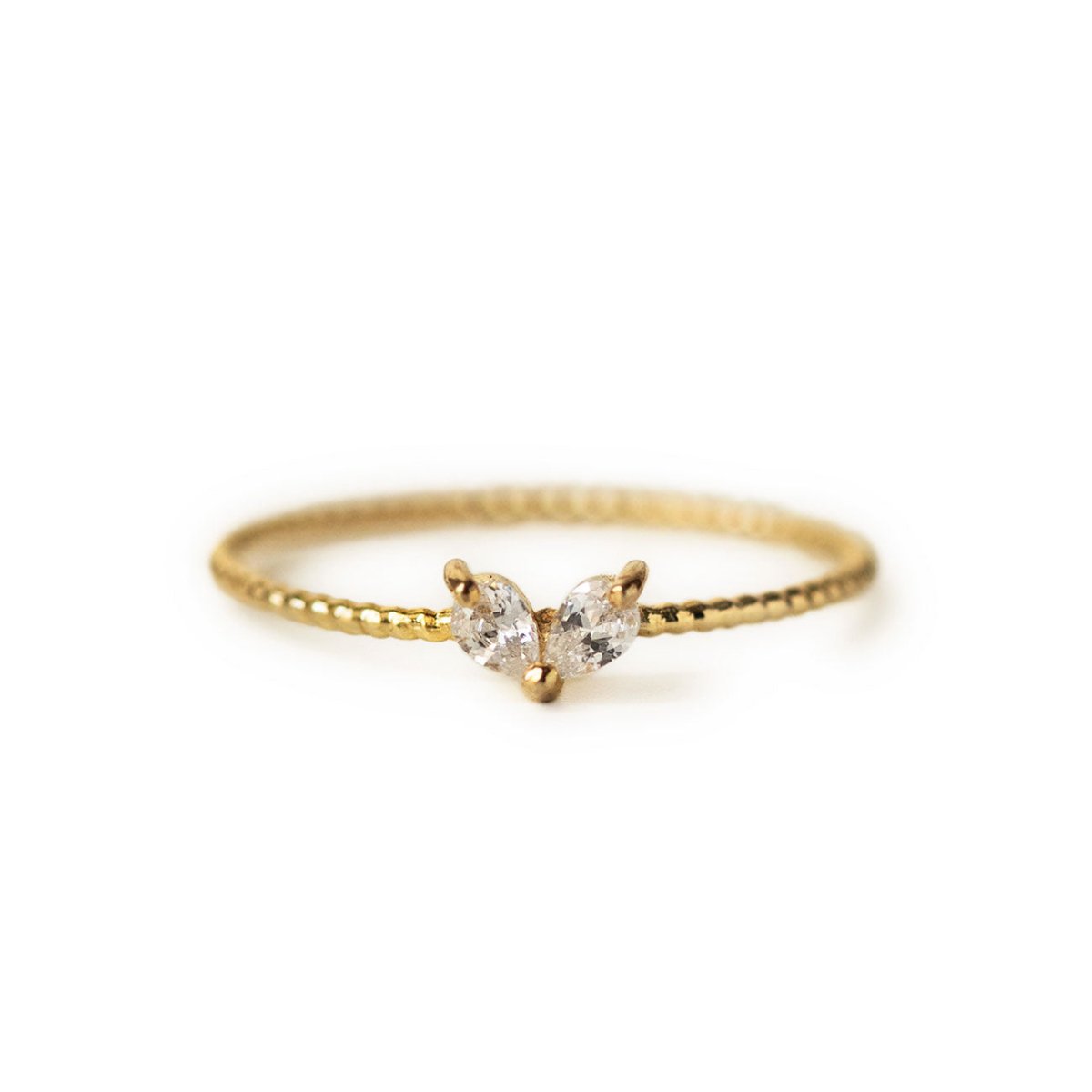 Gold vermeil thin ring with twin pear-cut white zirconia stones on a beaded band, on a white background