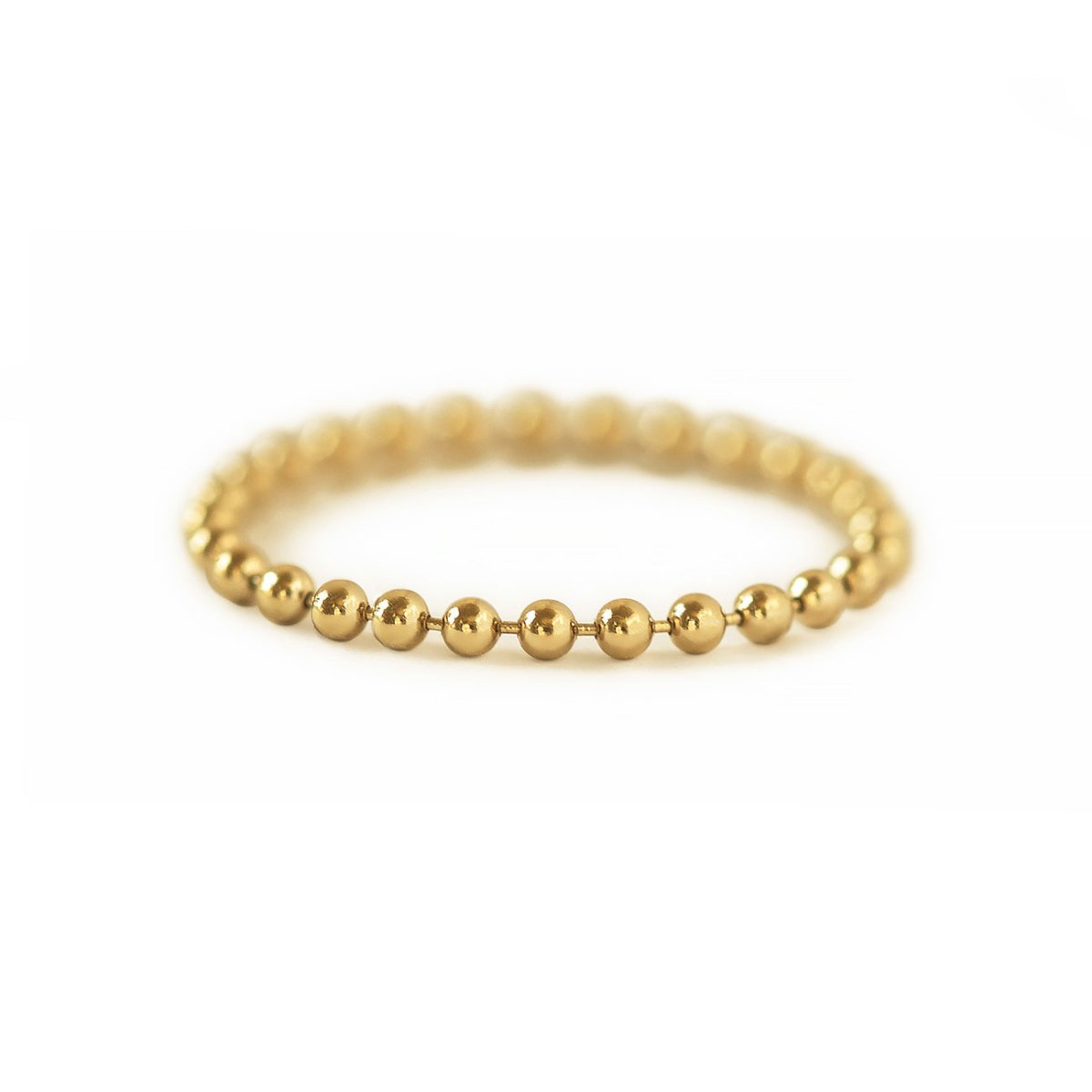 Gold-filled bead chain ring made of small round beads, on a white background