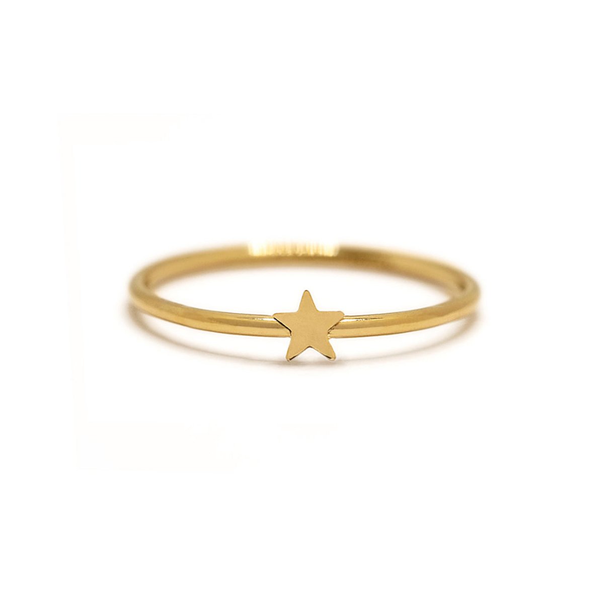 Gold-filled tiny star ring with a flat polished band, on a cream background