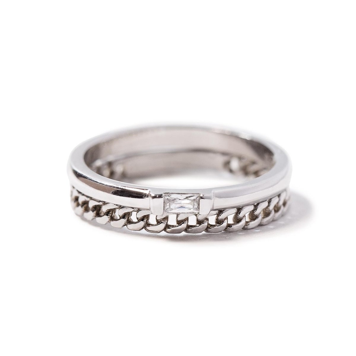 Sterling silver ring with a curb chain band and a baguette white zirconia stone, on a white background