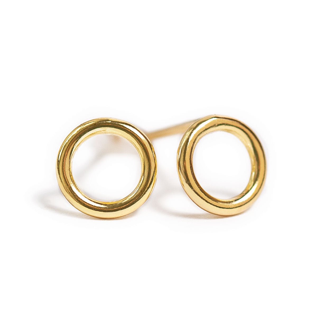 Pair of gold vermeil open circle stud earrings on a white background