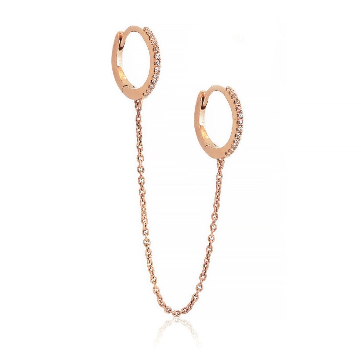 14K rose gold diamond pavé double huggie hoops linked by a chain, on a white background