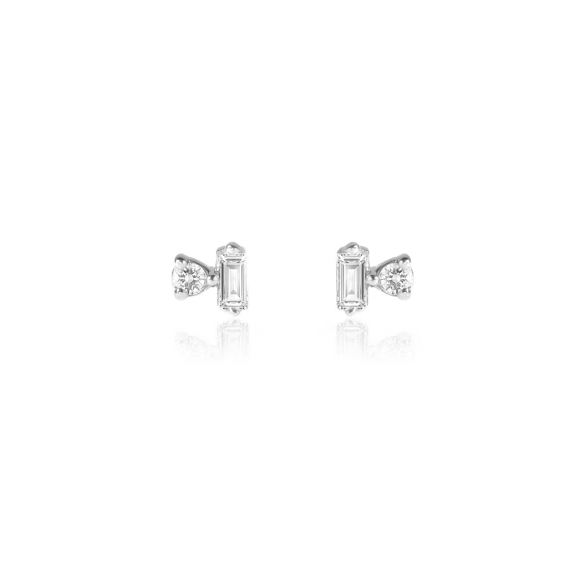 Pair of 14K white gold baguette and round diamond duet studs, on a white background