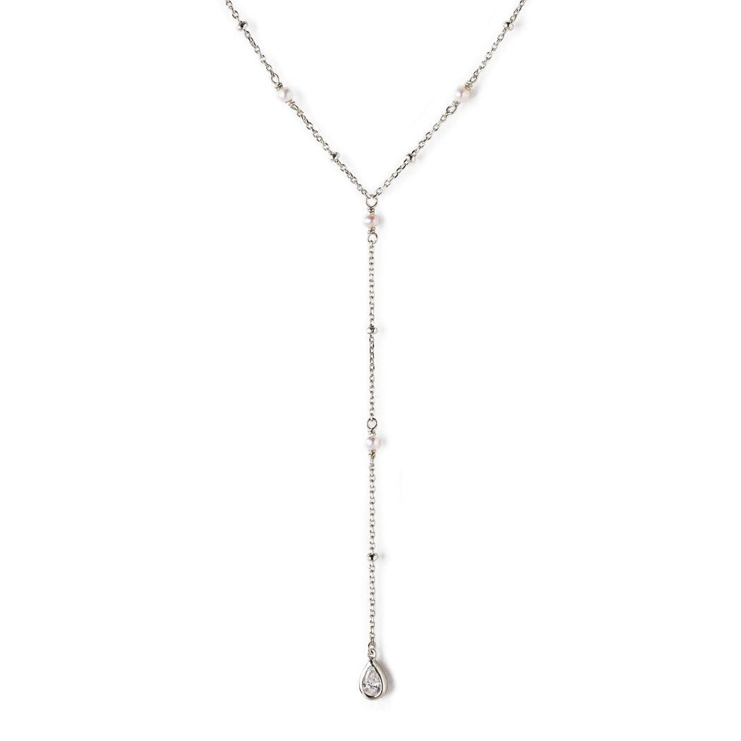 Sterling silver lariat necklace with pearl stations and a teardrop pendant, on a white background