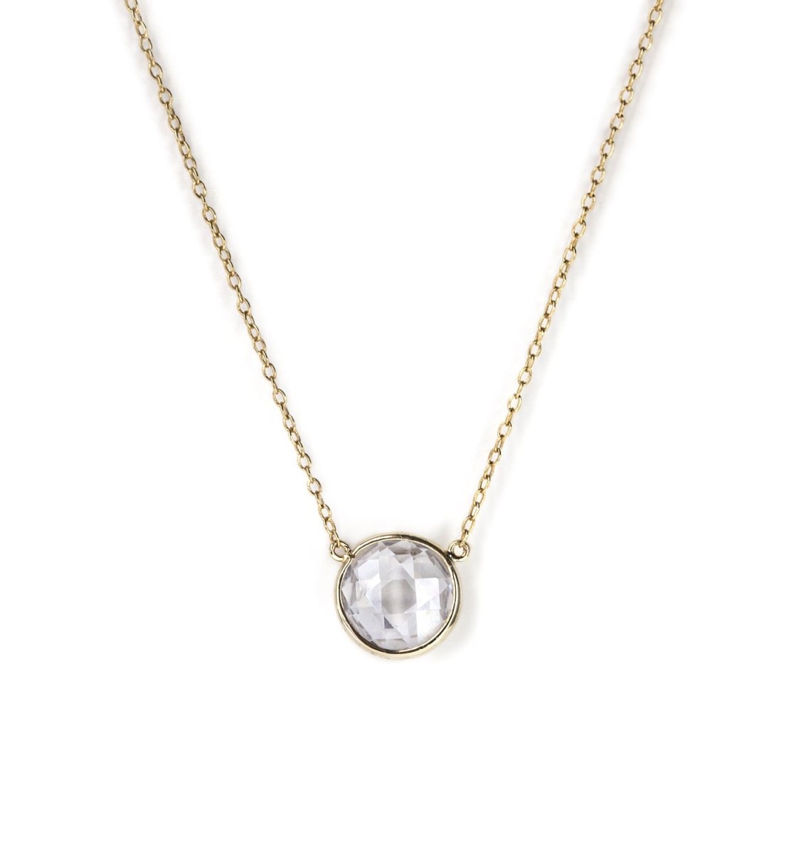 Gold vermeil necklace with a round faceted clear stone pendant, on a white background