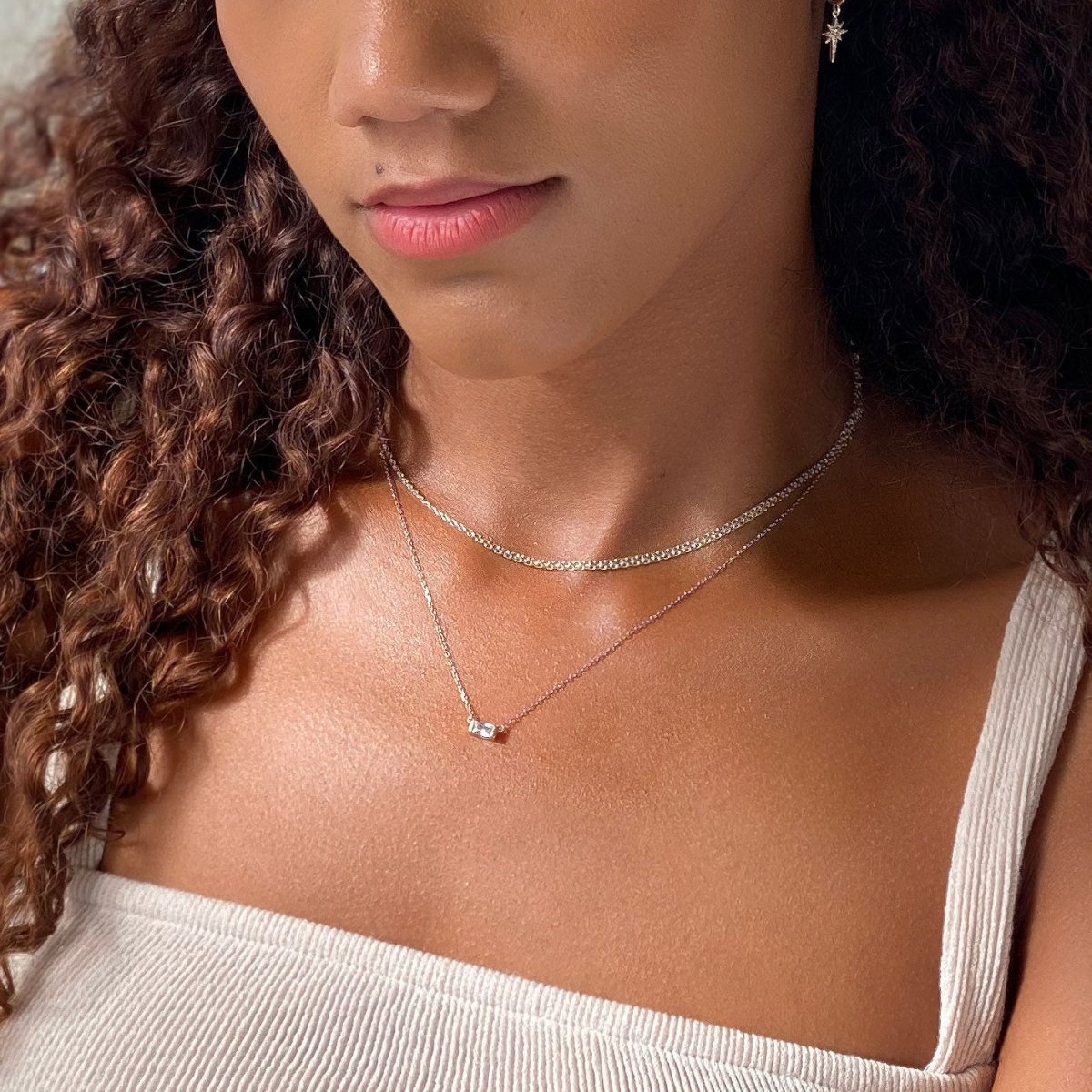 Sterling silver Bismark chain choker layered with a finer chain, shown on a model's neckline