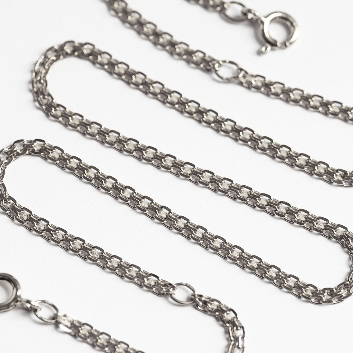 Sterling silver Bismark woven chain choker with a spring-ring clasp, laid on a white background