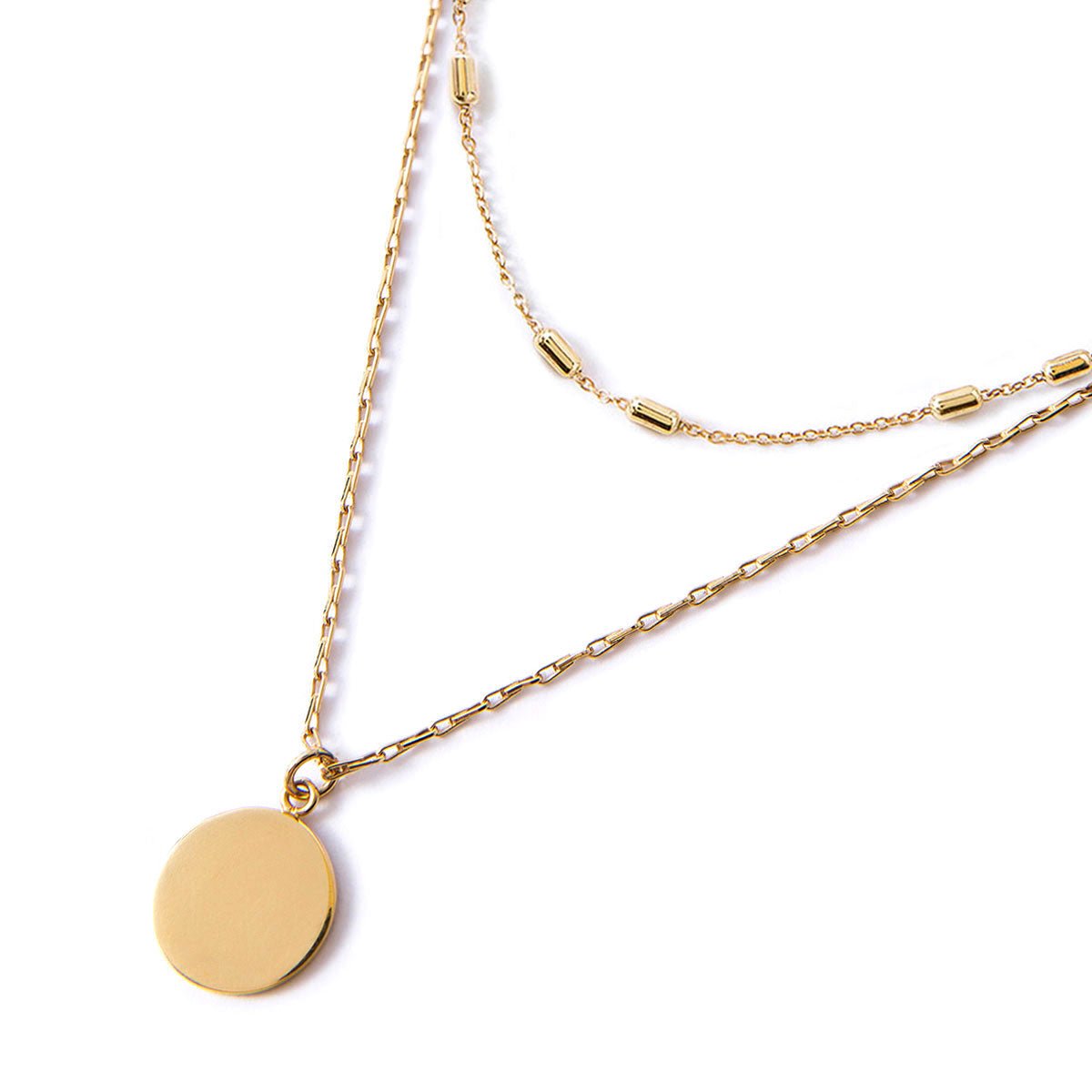 Gold vermeil layered necklace duo with a round disc pendant and beaded chain, on a white background