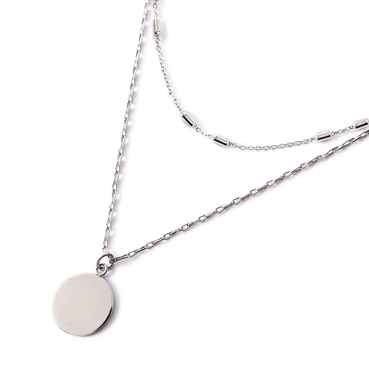 Sterling silver layered necklace duo with a round disc pendant and beaded chain, on a white background