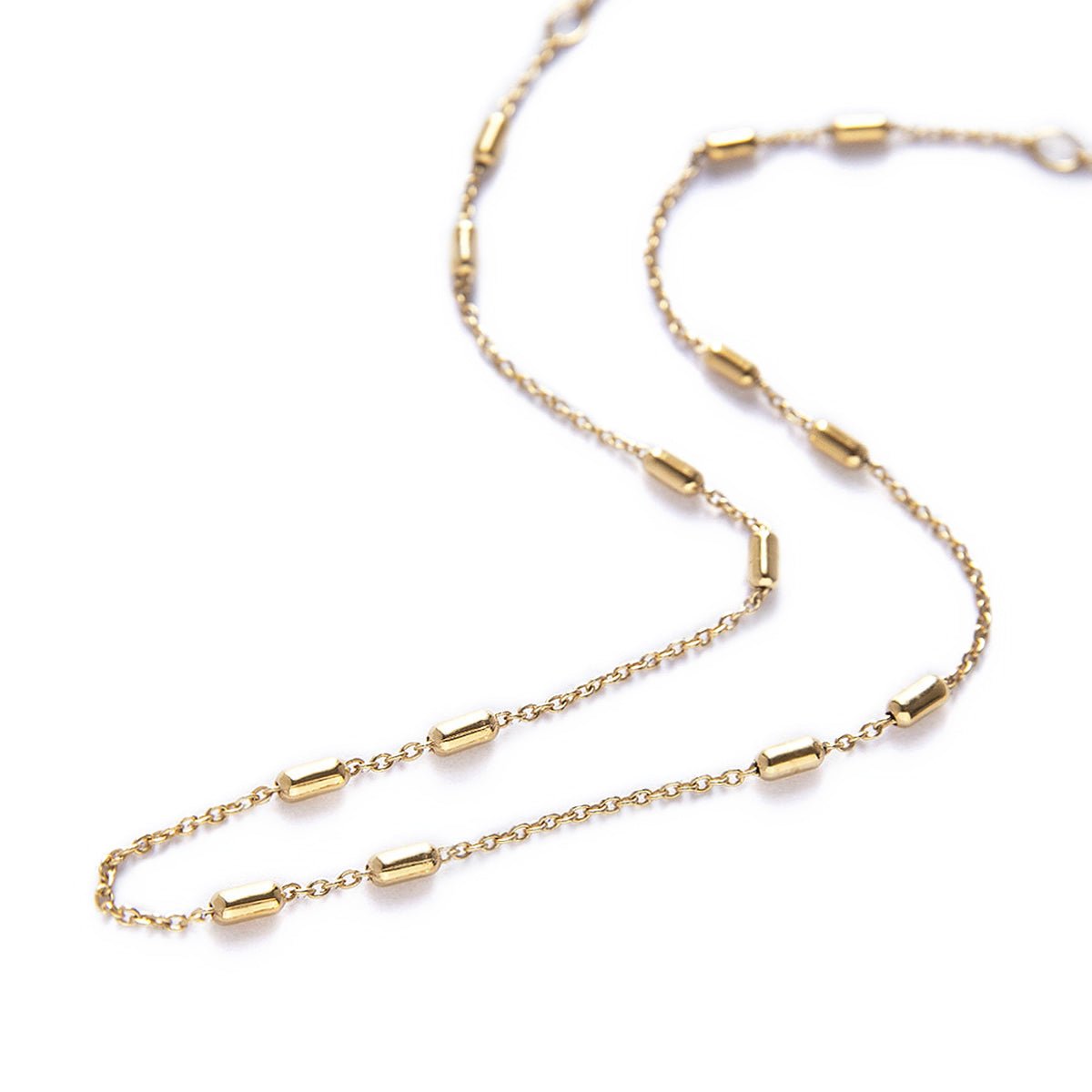 Gold vermeil chain choker with small bar stations, laid on a white background