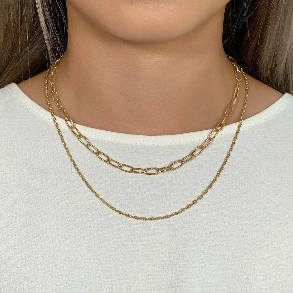 Gold vermeil paperclip and Marina chain duo, shown layered on a model's neckline