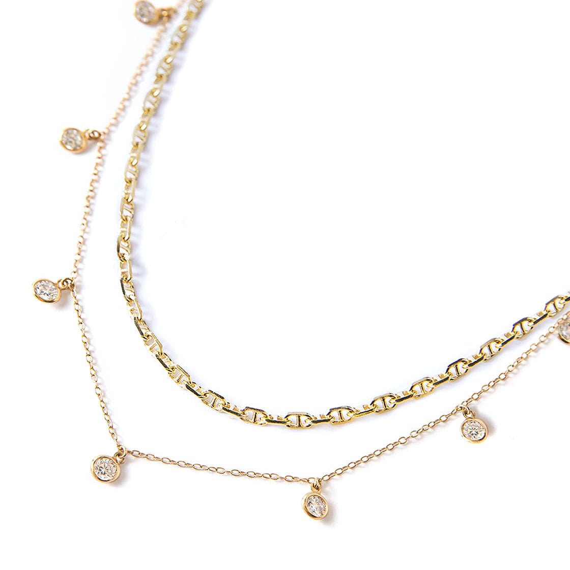 Gold vermeil layered necklace duo with bezel-set clear crystal drops on delicate chains, on a white background