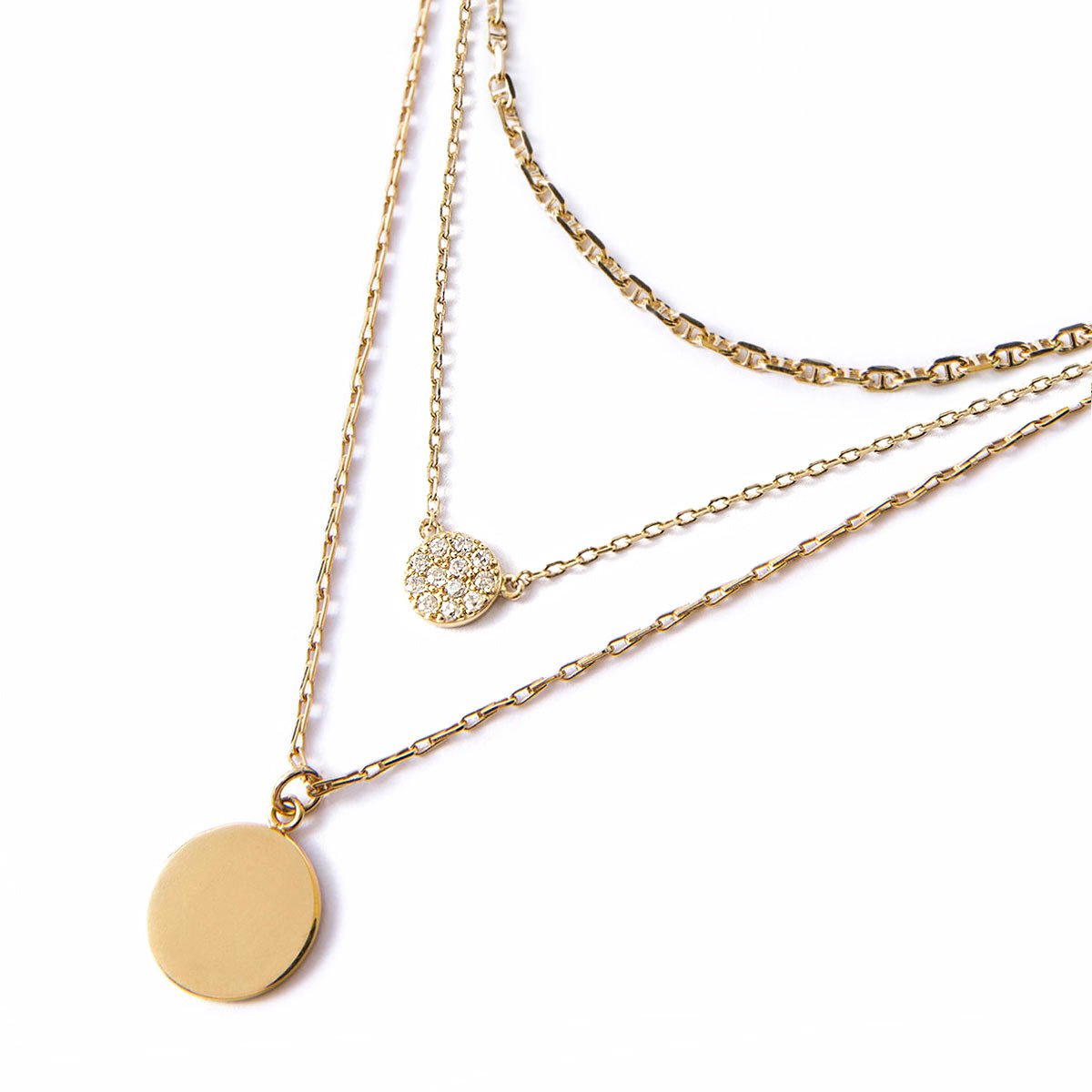 Gold vermeil Marina chain, clear crystal disc and plain disc pendant layered trio, on a white background