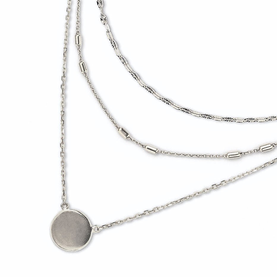 Sterling silver triple-layered necklace with mixed chains and a disc pendant, on a white background