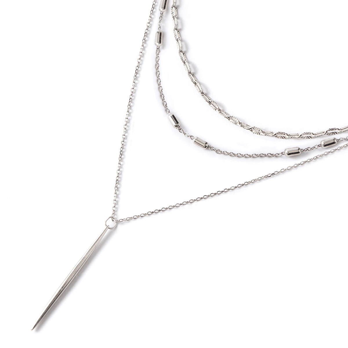 Sterling silver layered necklace set with patterned chains and a slim needle bar drop, on a white background