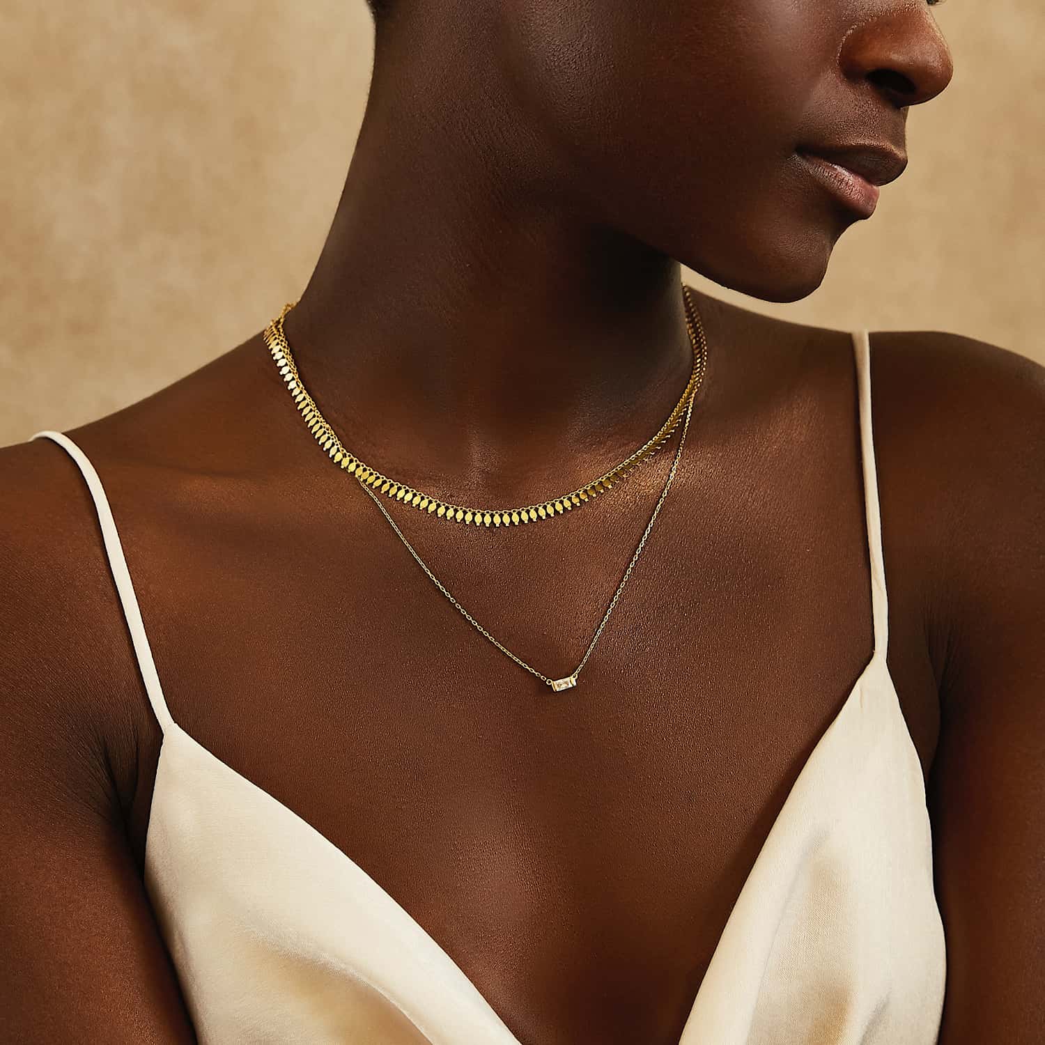 Gold vermeil fringe chain necklace layered with a fine chain, close-up detail on a white background