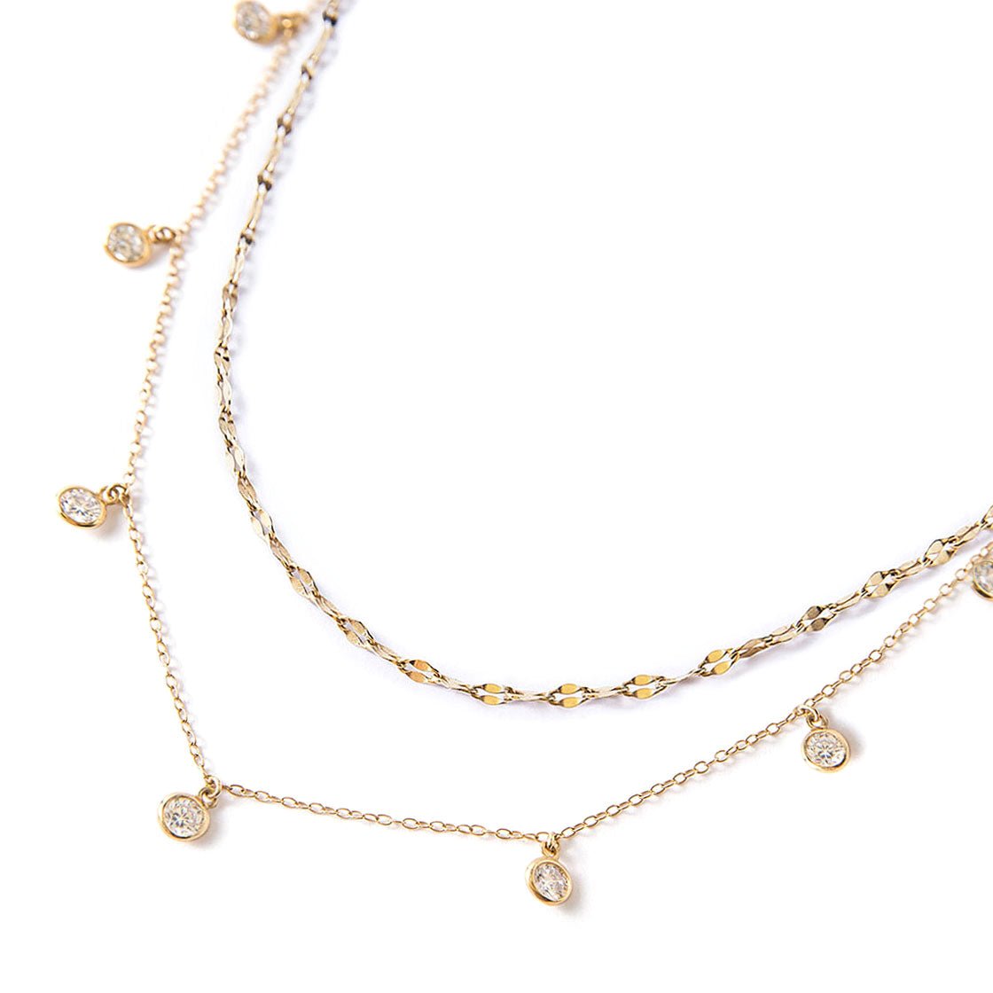Gold vermeil layered necklace duo with a textured chain and dangling round clear stones, close-up detail