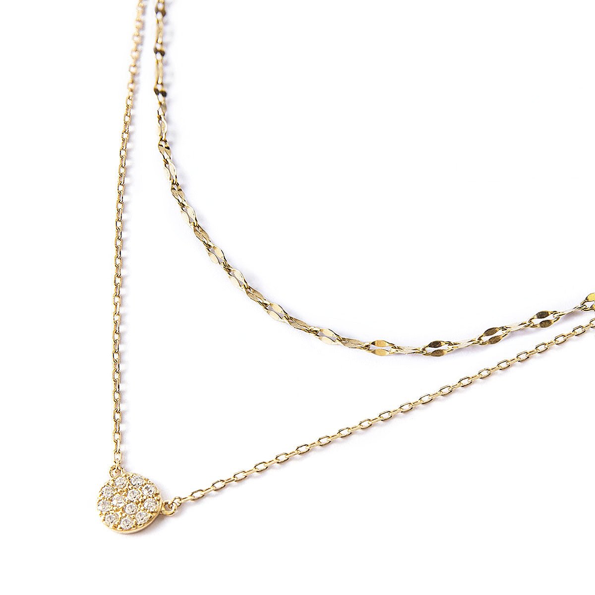 Gold vermeil layered necklace duo with a round pavé disc pendant set with clear stones, close-up detail