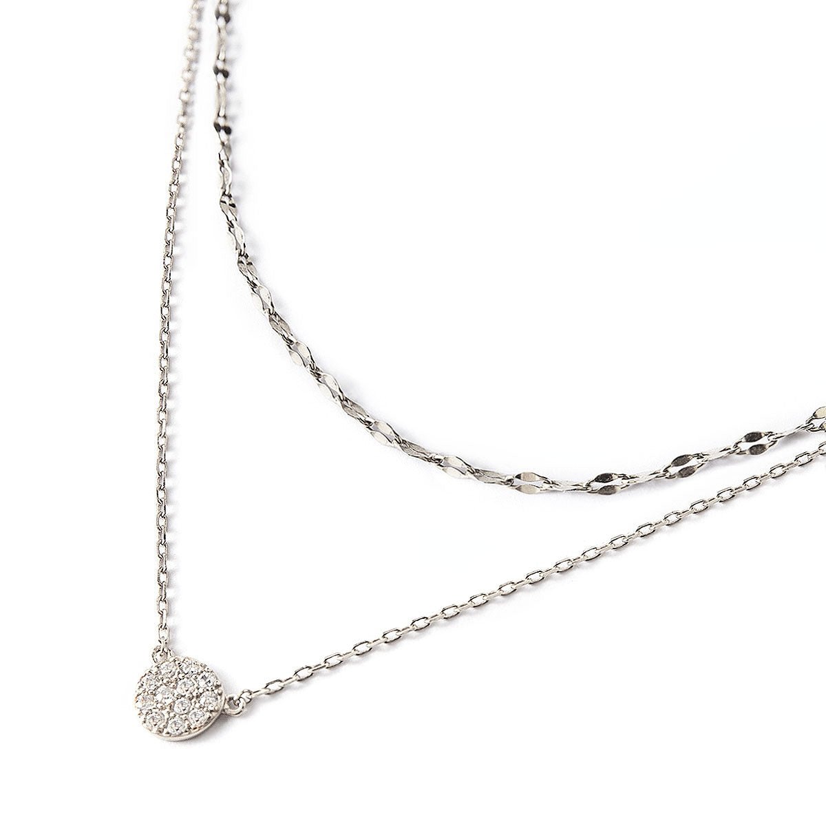 Sterling silver layered necklace duo with a round pavé disc pendant set with clear stones, close-up detail