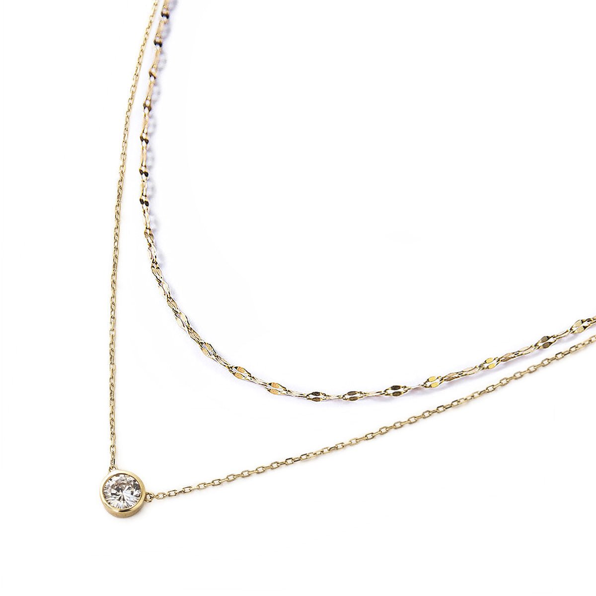 Gold vermeil layered necklace duo with a bezel-set round clear solitaire stone, on a white background