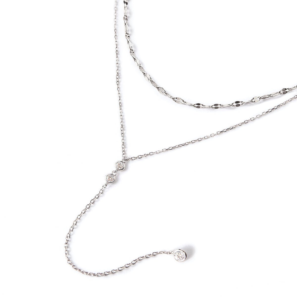 Sterling silver layered lariat duo with a drop chain and clear stones, on a white background