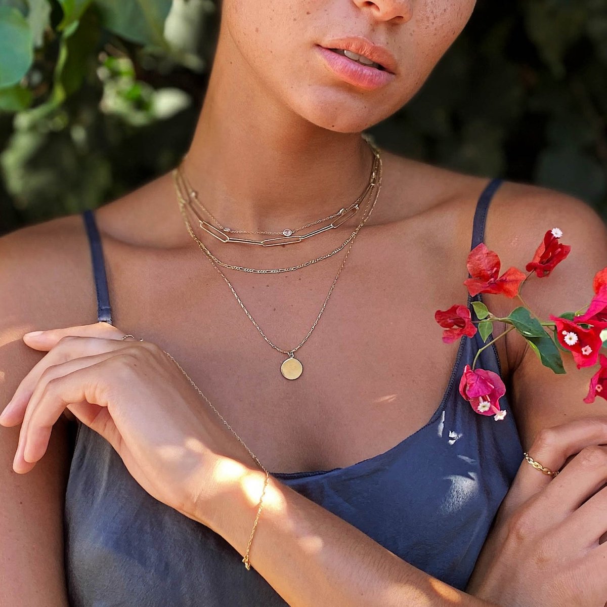Gold vermeil disc pendant necklace shown layered on a model with paperclip and beaded chains