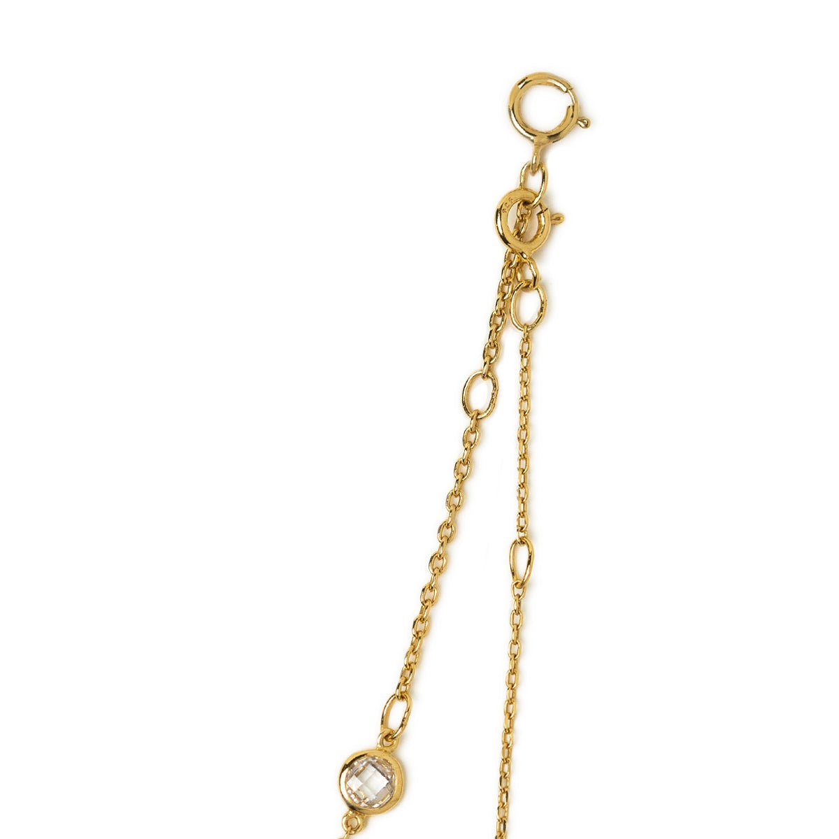 Close-up of the gold vermeil spring-ring clasp and white zirconia station on a white background