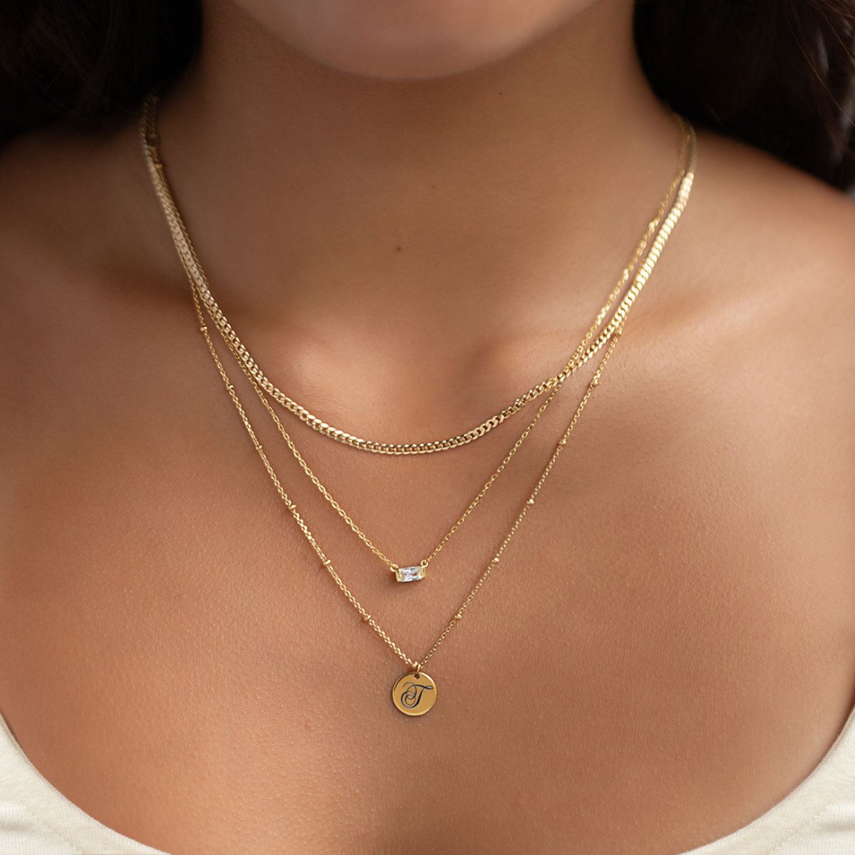 Gold vermeil flat Cuban curb chain necklace, shown loose in an S-curve on a white background