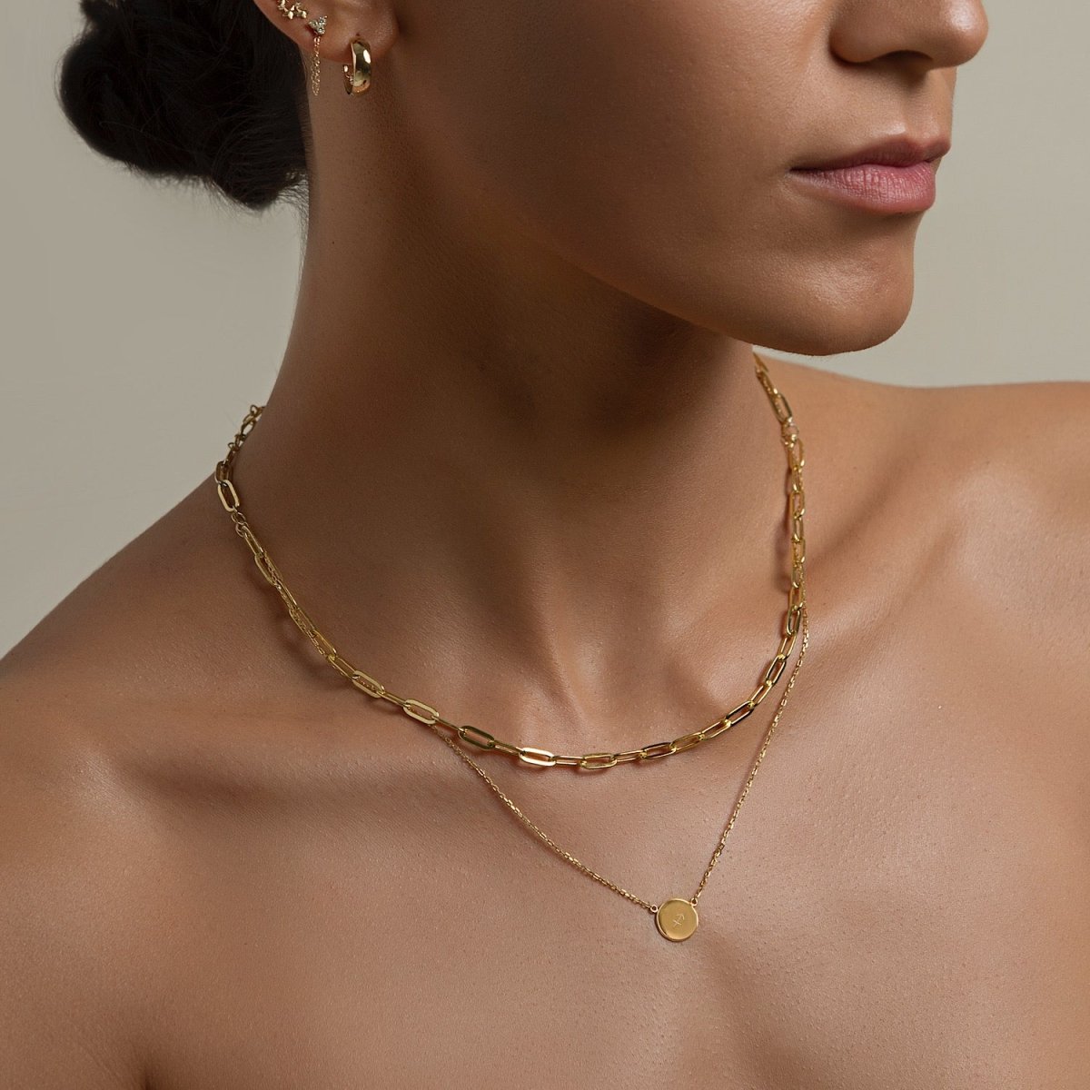 Gold vermeil thick paperclip link chain necklace layered with a disc pendant chain, shown on a model's neck