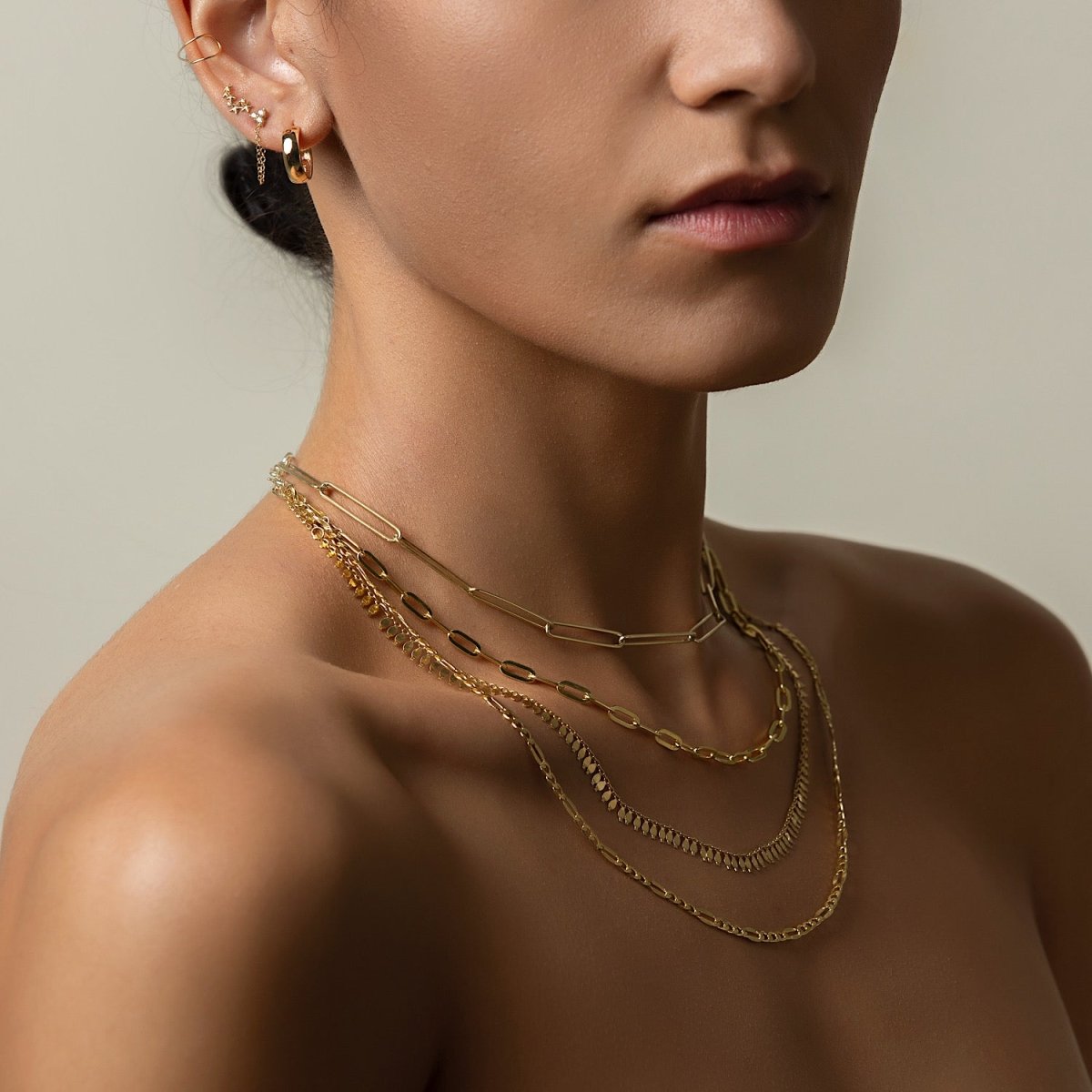 Gold vermeil long link paperclip chain necklace, layered with other chains on a model
