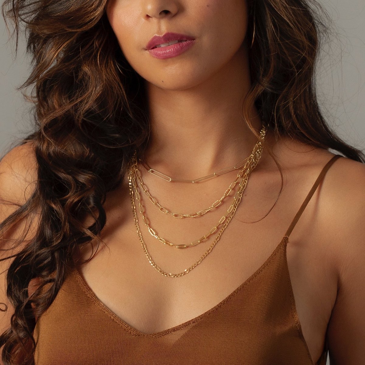 Gold vermeil figaro chain necklace styled in a layered necklace stack, shown on a model's neckline