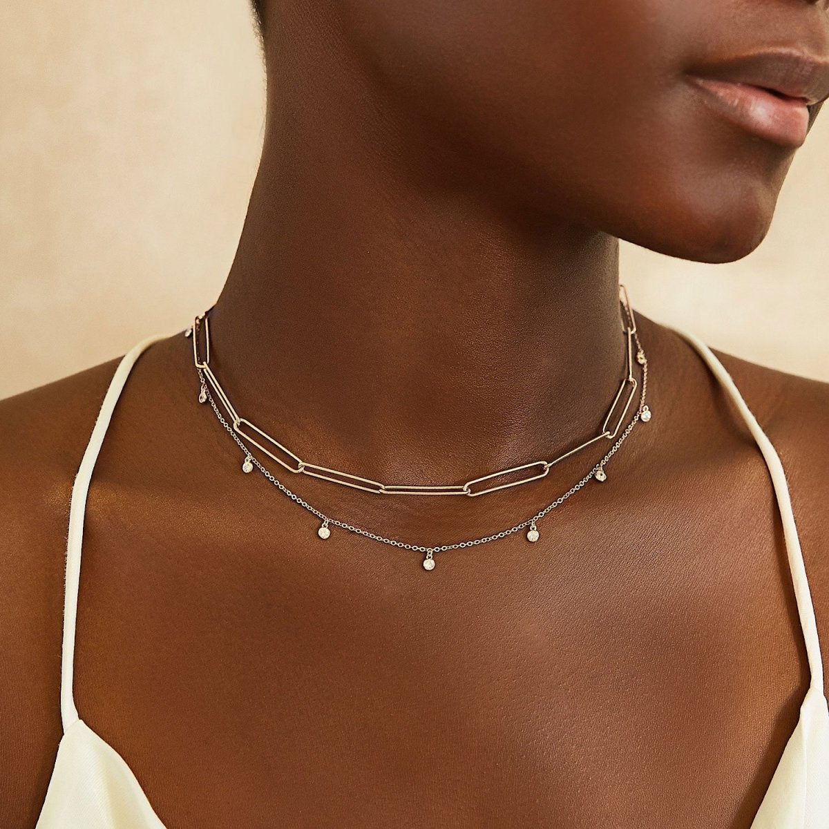 Sterling silver long link paperclip chain necklace, layered on a model's neckline