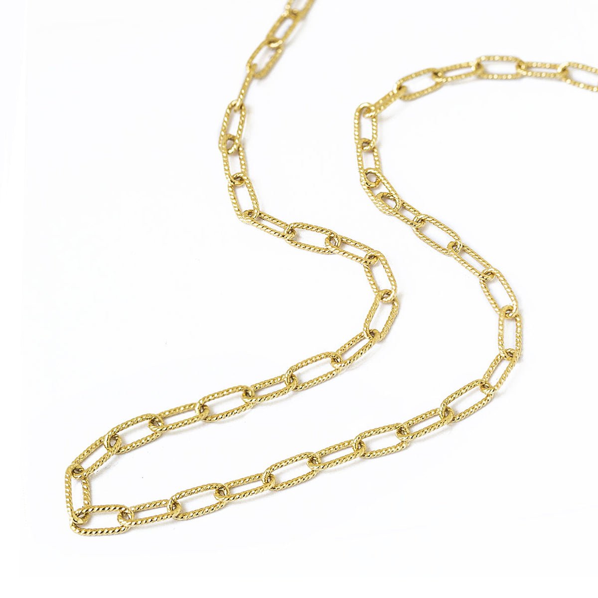 Gold vermeil oval link chain necklace layered with other chains, shown on a model's neckline