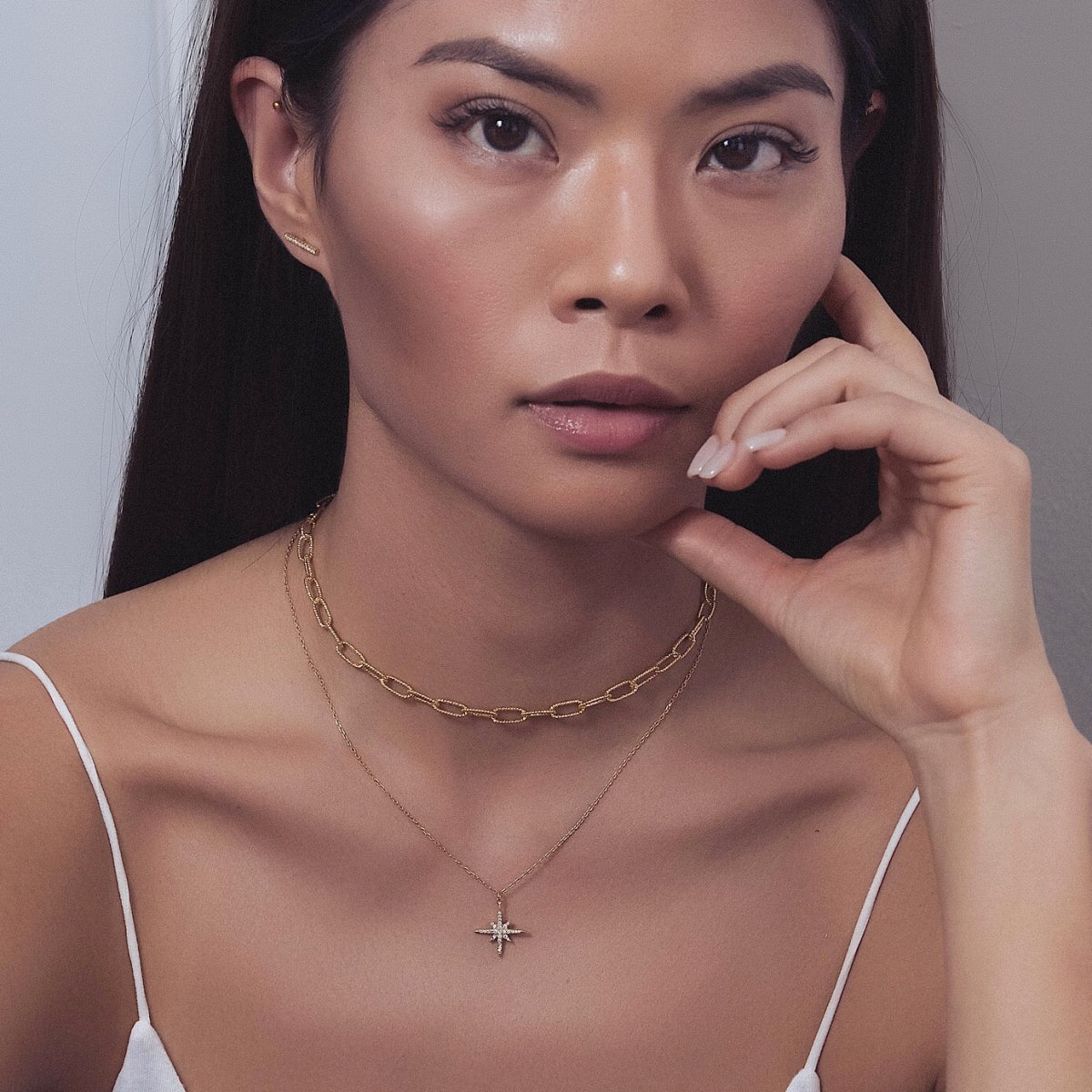 Gold vermeil chunky link chain necklace worn as a choker on a model's neckline