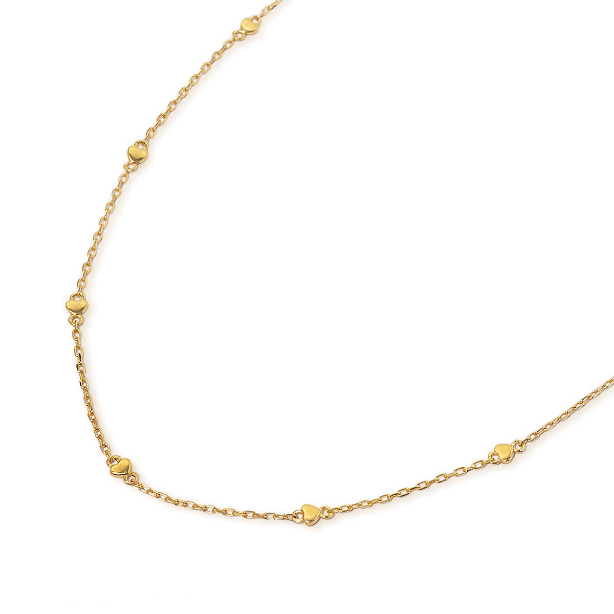 Gold vermeil heart-station chain necklace with small flat hearts, laid on a white background